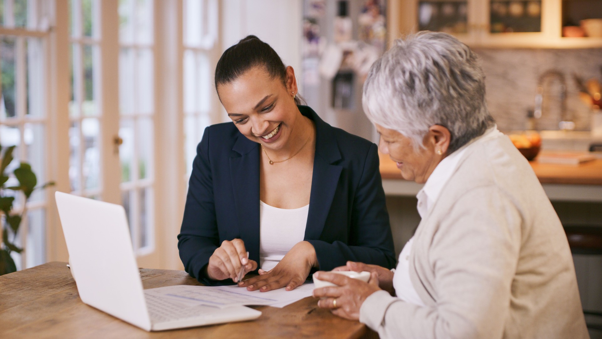 Shot of a consultant going through paperwork during a meeting with a senior woman at home Shot of a consultant going through paperwork during a meeting with a senior woman at home
